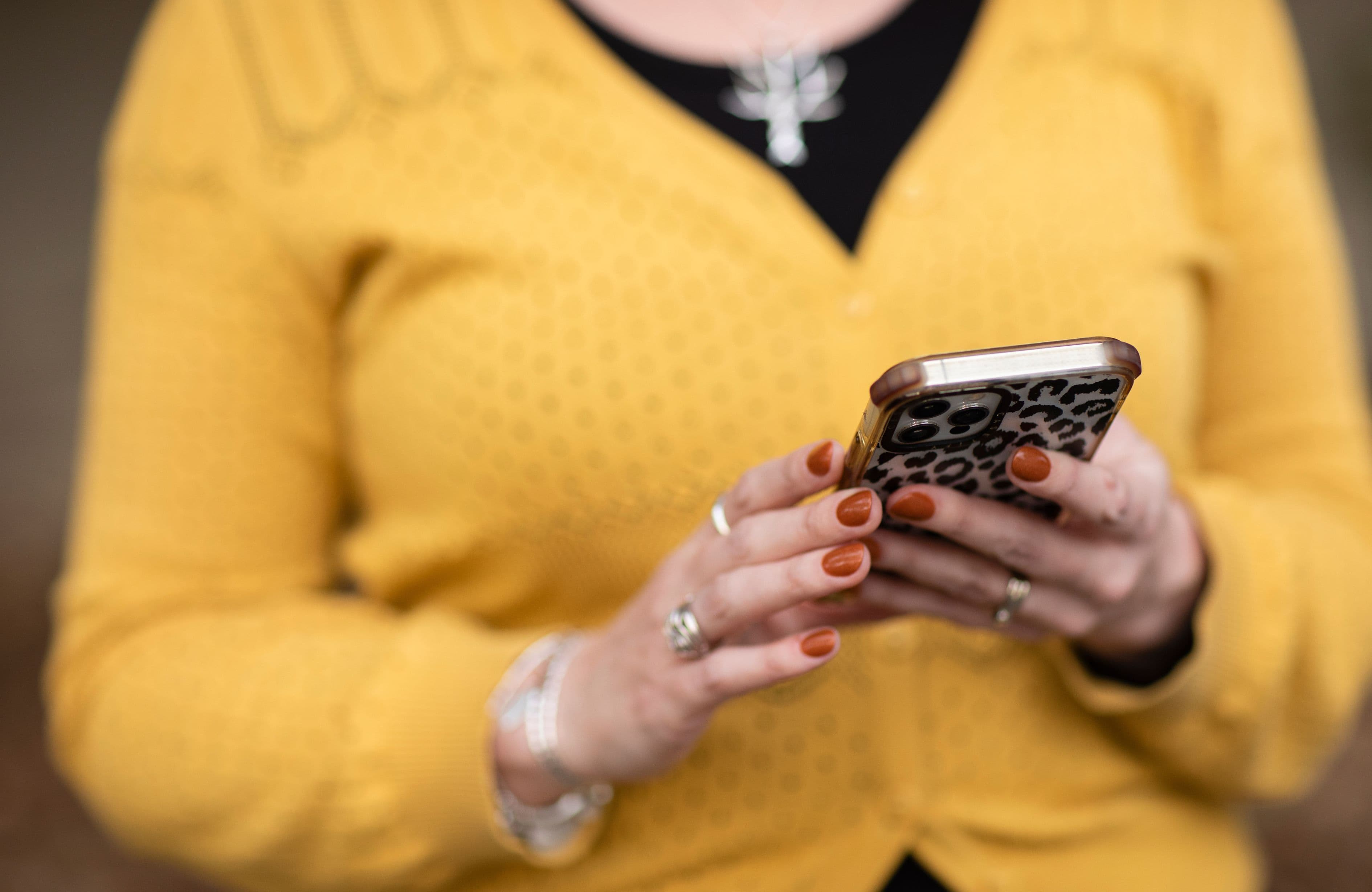 A close up of a woman holding a mobile phone.