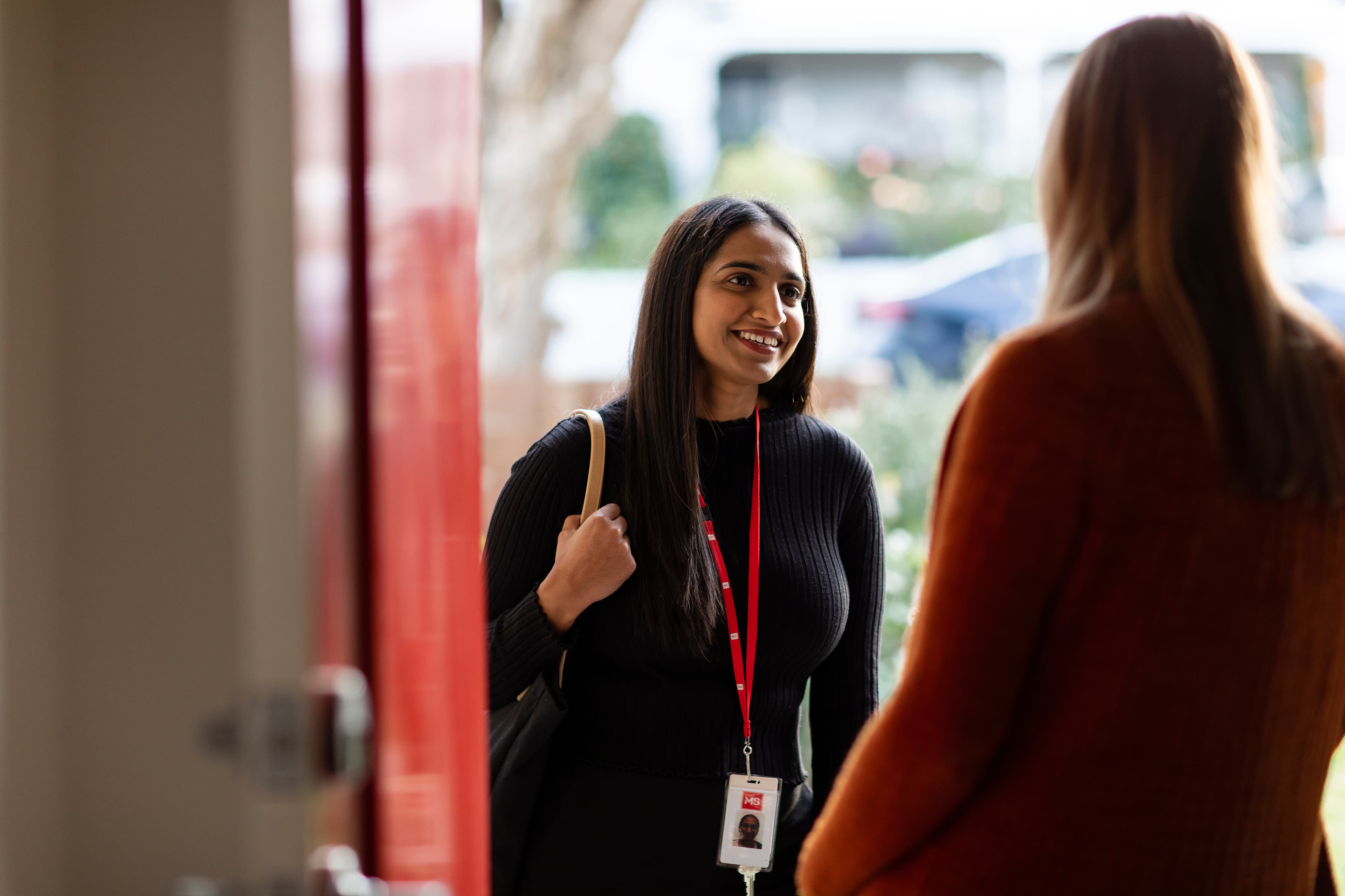 An employee of MS Plus doing a home visit to a client.
