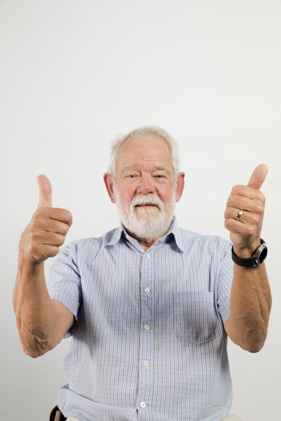 person in a blue shirt making the thumbs up gesture