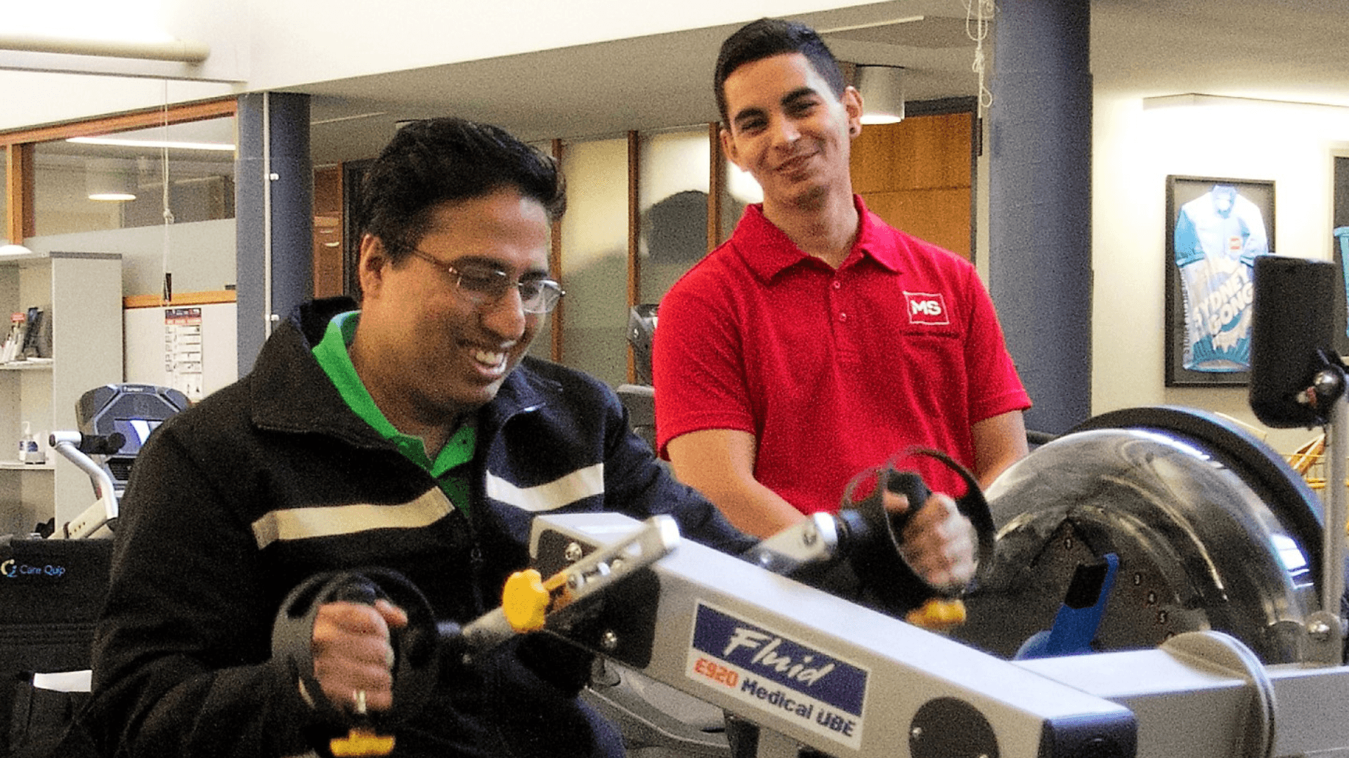 An MS Plus client working out at the gym with an MS Plus occupational therapist.