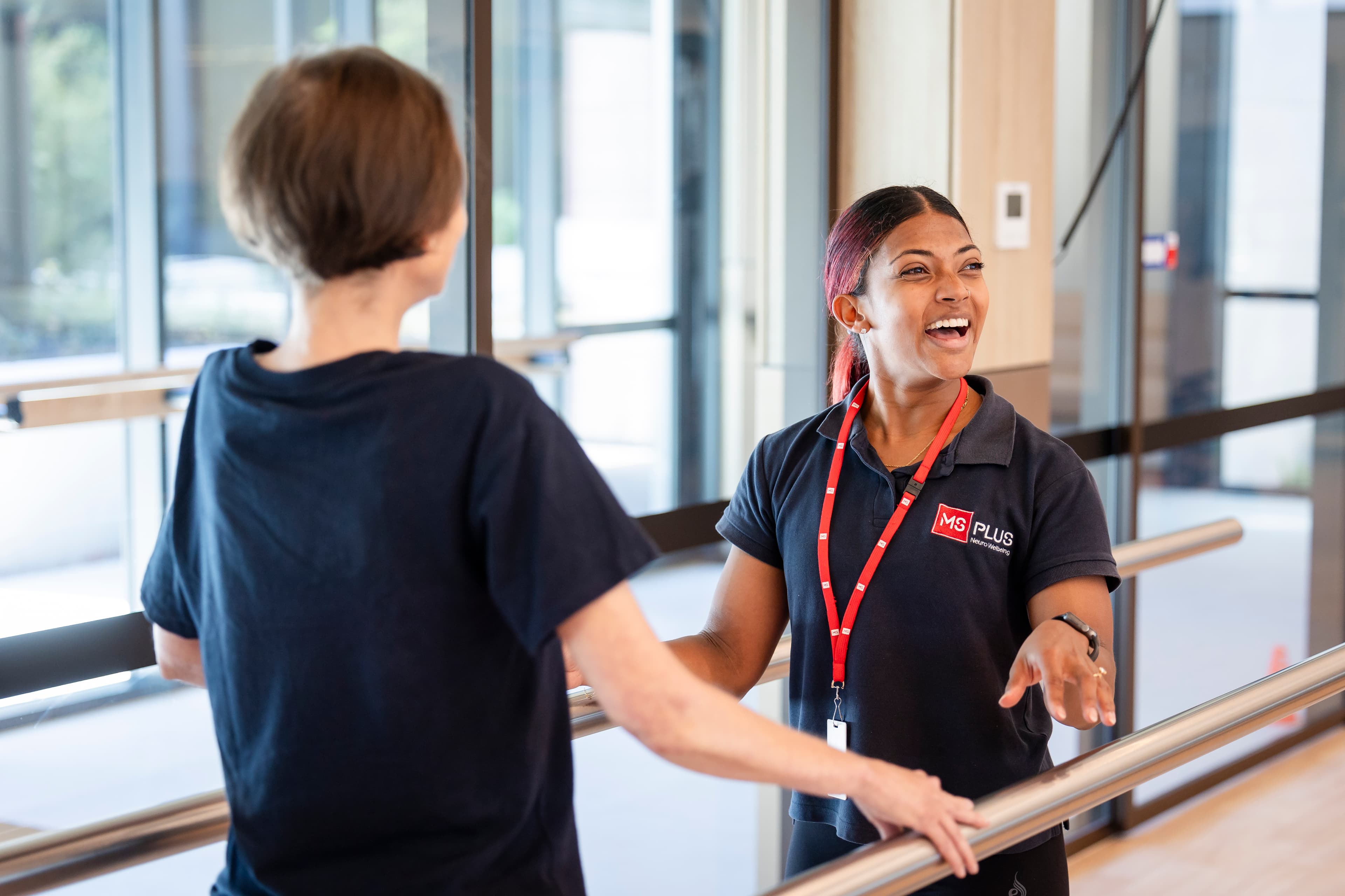 MS Plus Staff joyfully helping an individual