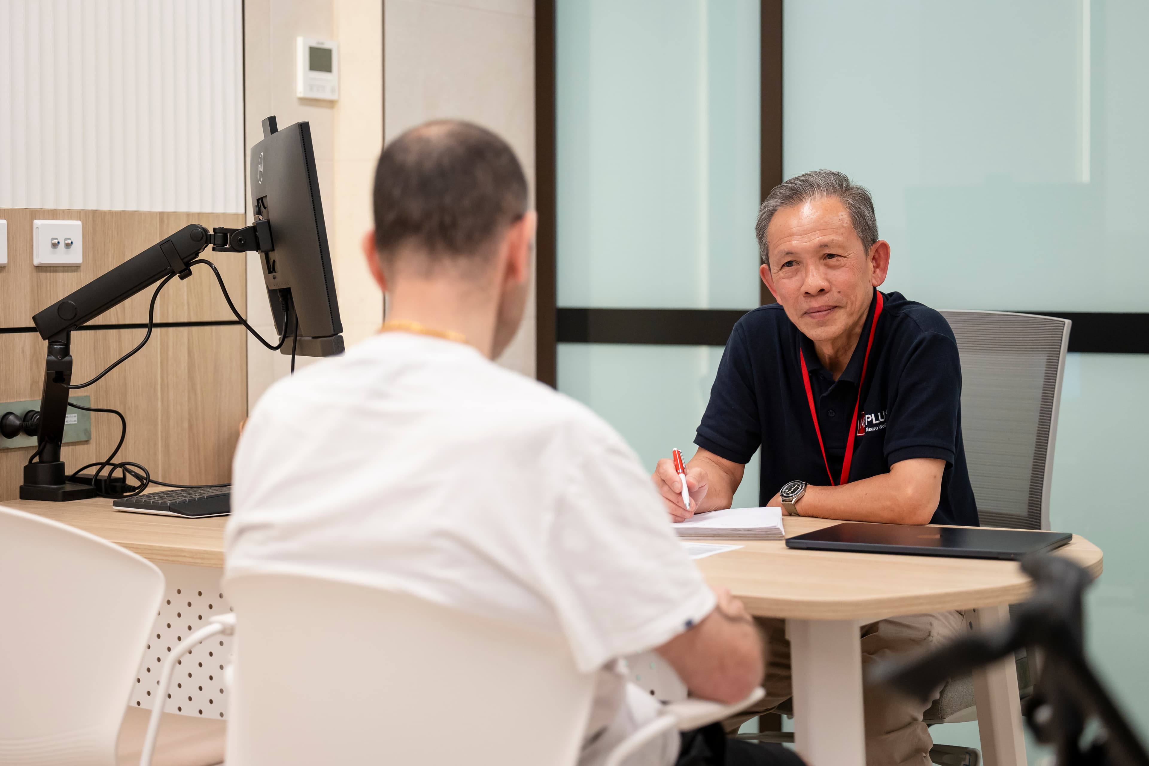 A MS Plus individual having conversation with a man