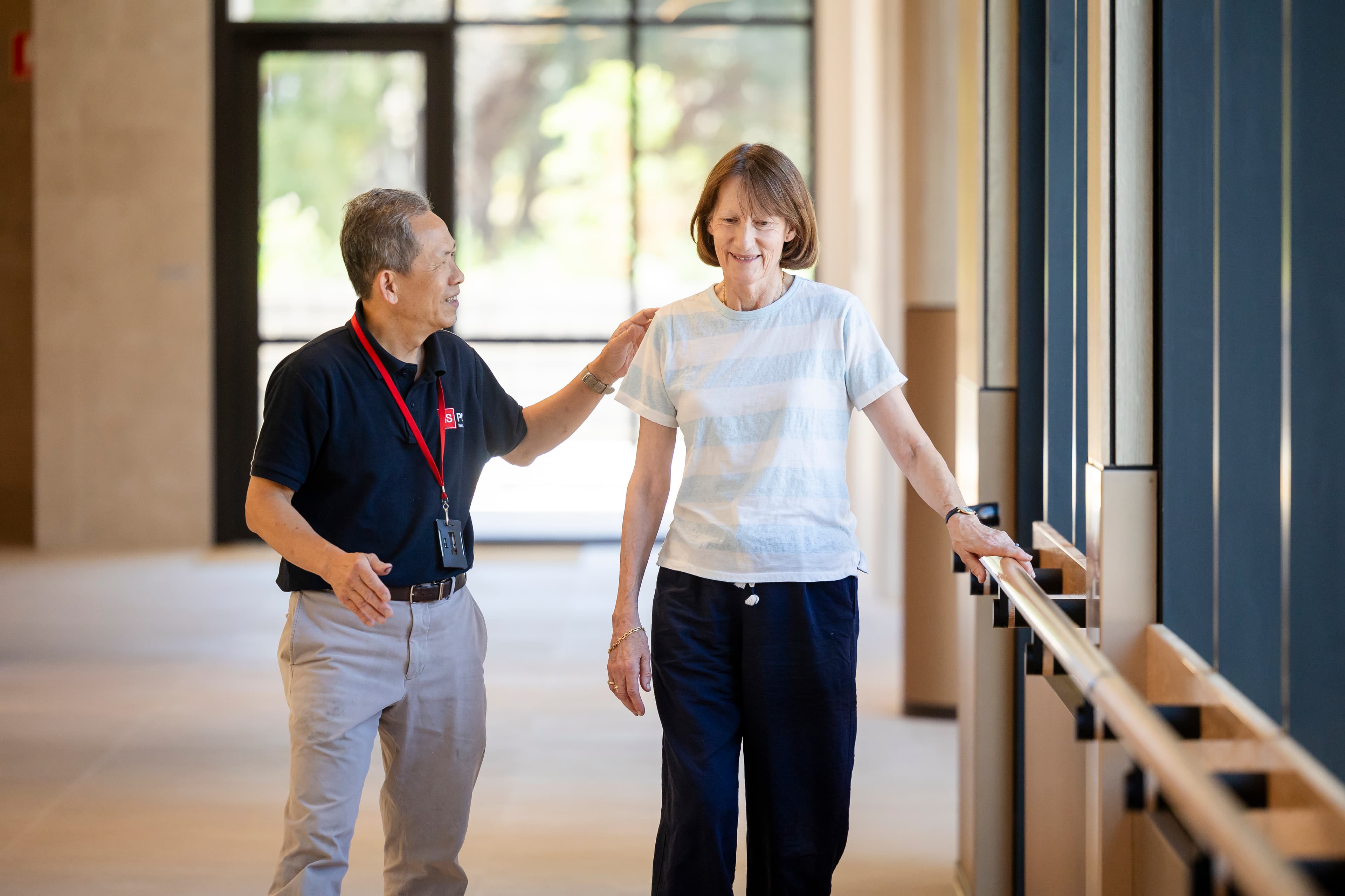 A MS Plus staff walkin with a woman