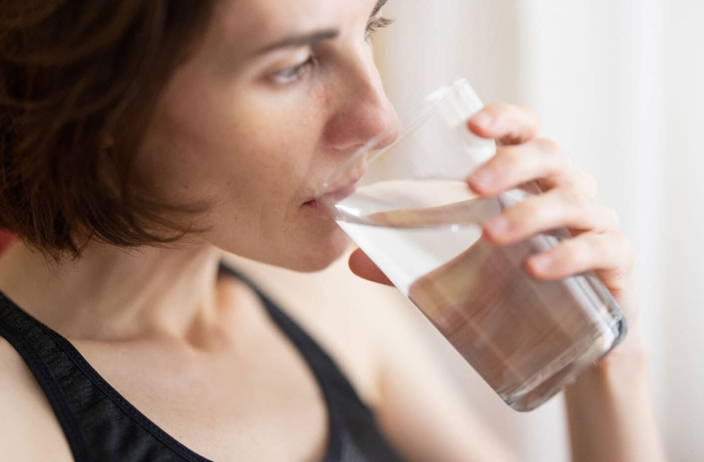 Woman with ms drinking water for heat sensitivity