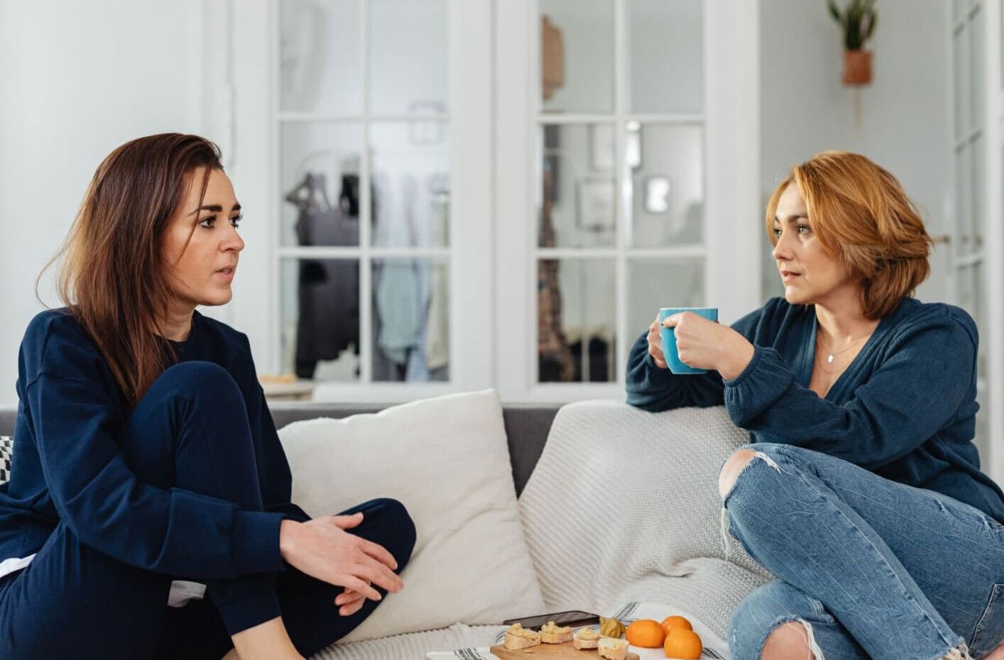 Two women discussing in a peer support group