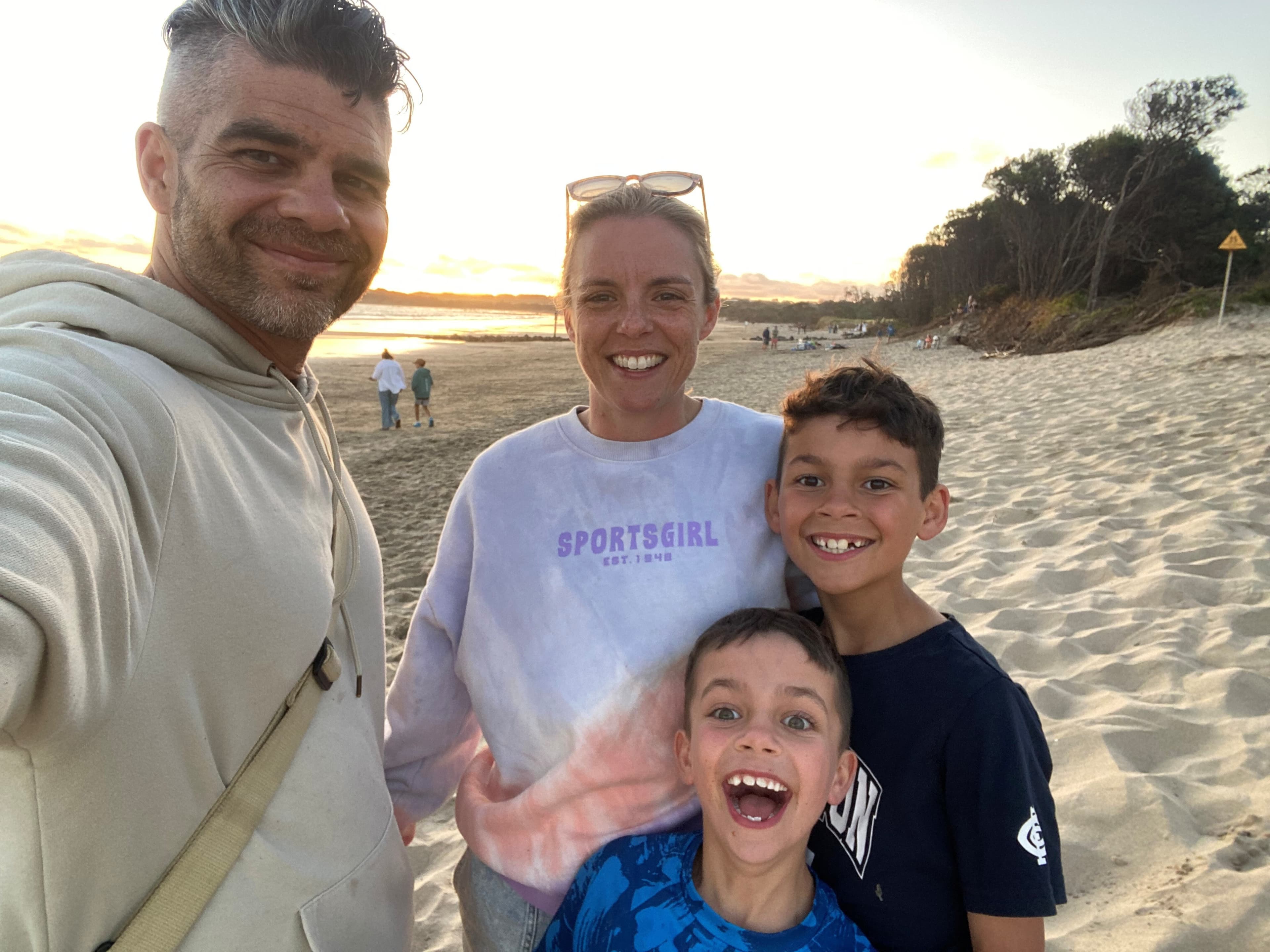 Kate and her husband and two children on a beach