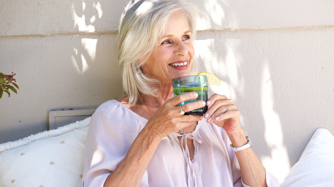 Older woman drinking water