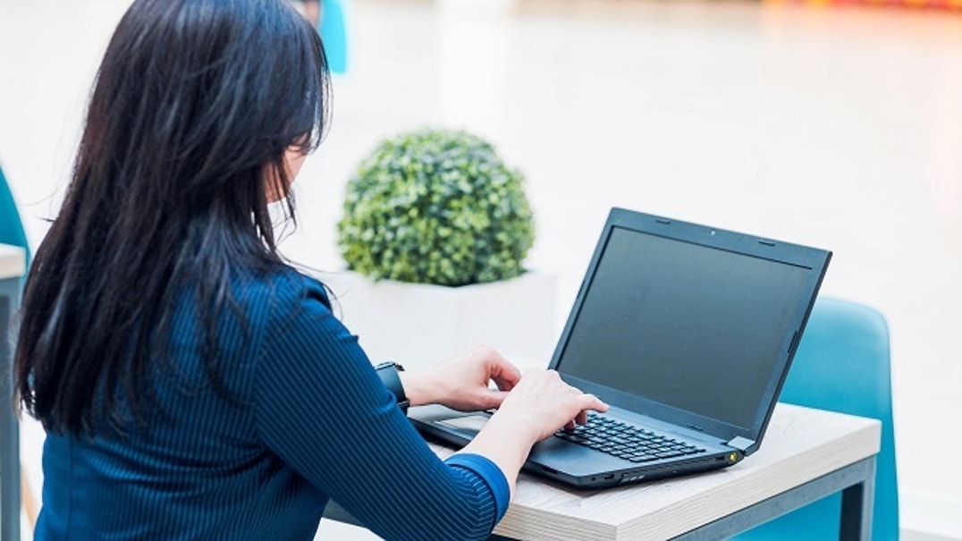 Bigstock Business Woman Sits With Her B 335801635 1