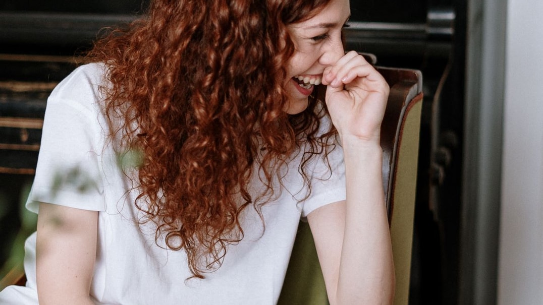 Person with red hair laughing
