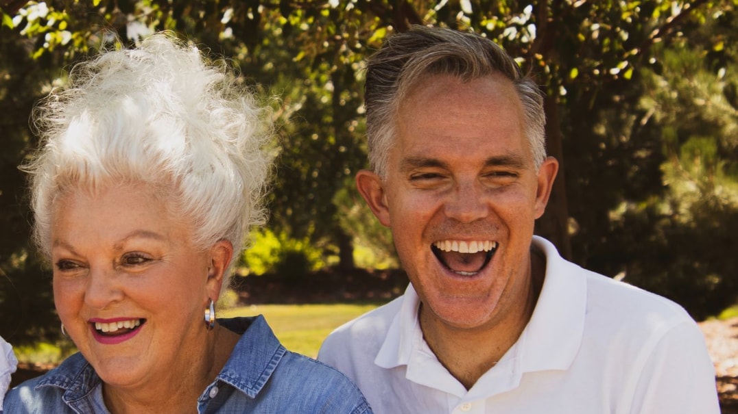 Two people laughing outside