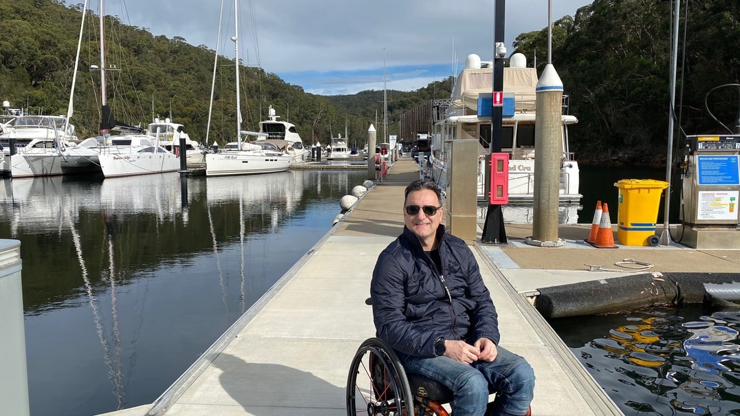 Male in wheelchair on boat dock